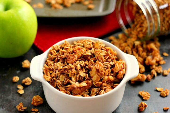 apple pie granola in a dish in front of a baking pan