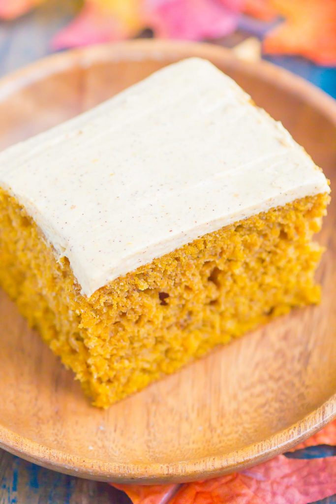 a slice of pumpkin spice cake with cream cheese frosting