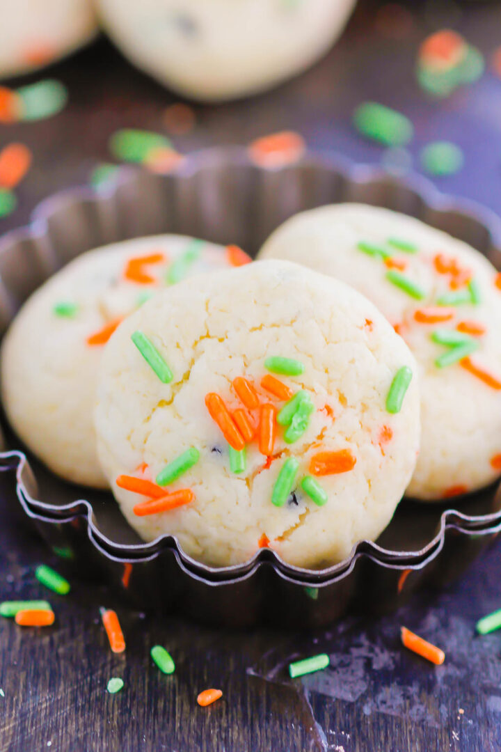 These Halloween Cookies are soft, fluffy, and made with just 4 ingredients. The sprinkles lend some Halloween fun and using cake mix makes it so easy. It's a simple recipe for a spooky night! #halloween #cookies #easy #homemade #spooky #simple #recipe #halloweenrecipes #cakemixcookies #cookierecipes