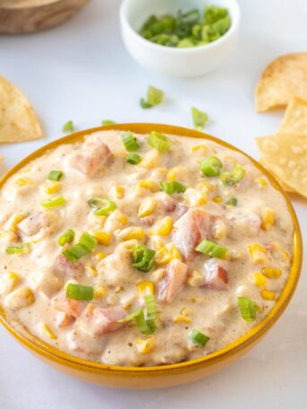 corn dip in a brown bowl