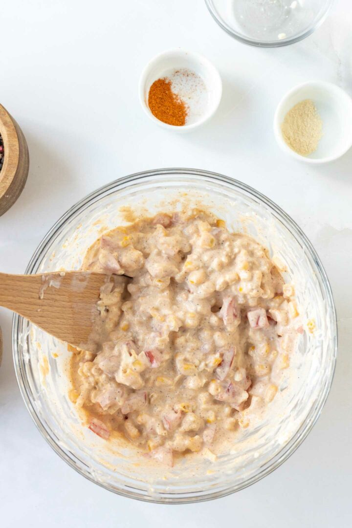 corn dip ingredients mixed in a glass bowl