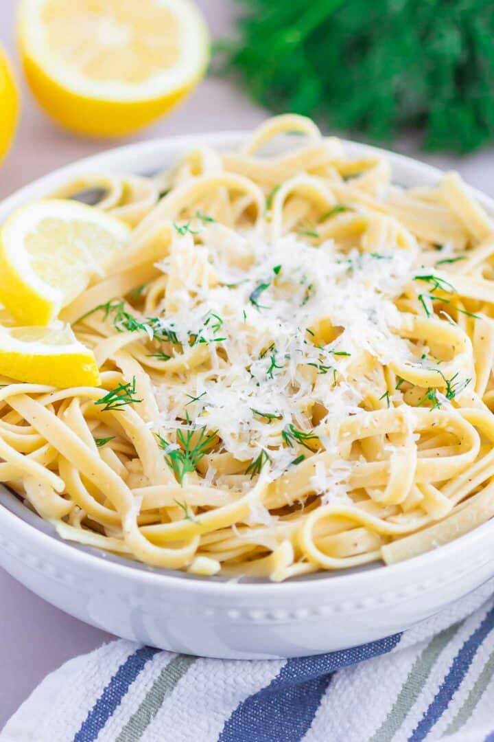 pasta in a white bowl with cheese on top