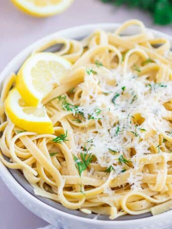 pasta in a white bowl with parmesan cheese on top