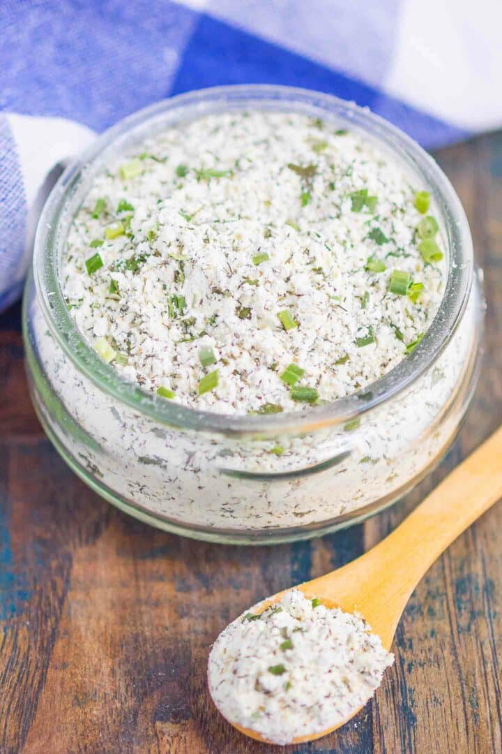 ranch seasoning mix in a glass jar with a wooden spoon