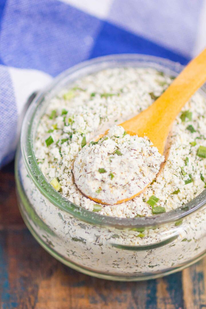 ranch seasoning mix in a glass jar with a wooden spoon