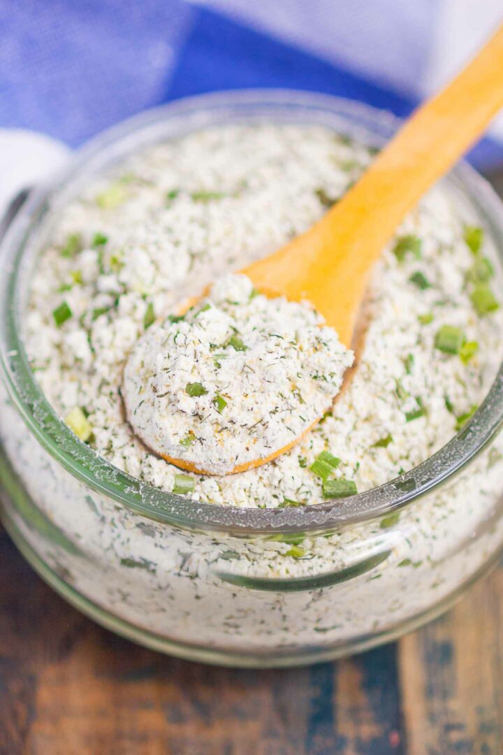 ranch seasoning mix in a glass jar with a wooden spoon