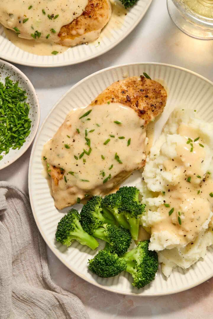 chicken with mashed potatoes and broccoli on a white plate