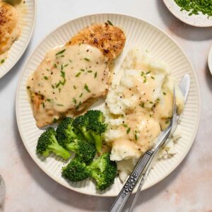 chicken with mashed potatoes and broccoli on a white plate