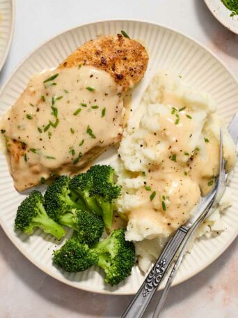 chicken with mashed potatoes and broccoli on a white plate