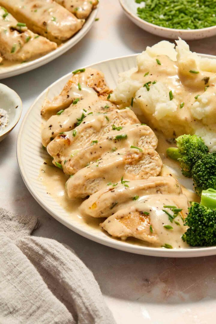 chicken with mashed potatoes and broccoli on a white plate