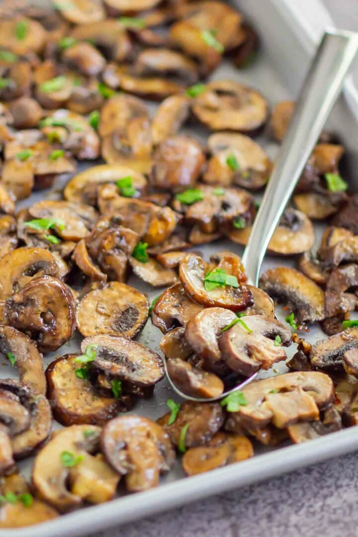 a spoonful of mushrooms on a sheet pan