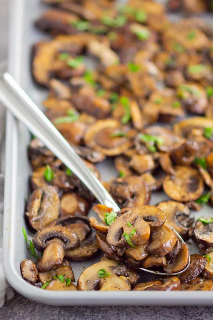 a spoonful of mushrooms on a sheet pan