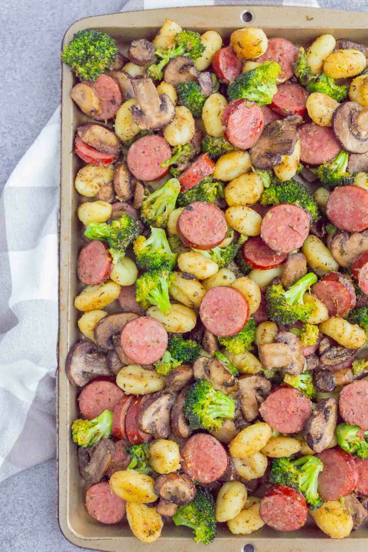 sausage, gnocchi, broccoli and mushrooms on a sheet pan