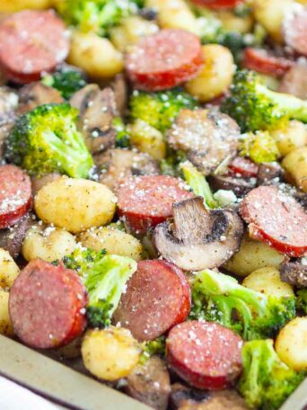 sausage, gnocchi, broccoli and mushrooms on a sheet pan