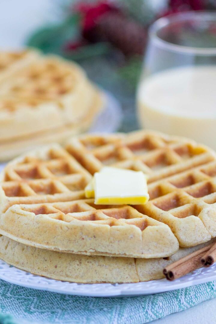 eggnog waffles with butter on a white plate