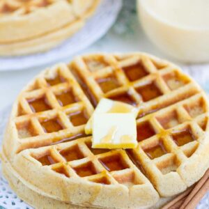 waffles with butter and syrup on a white plate