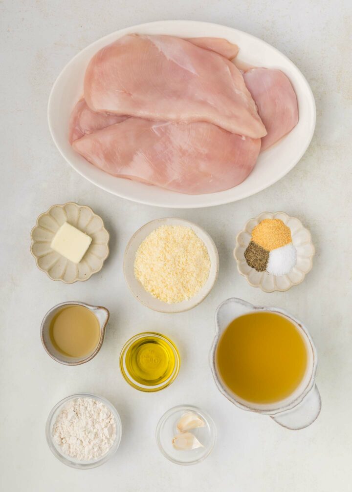 ingredients for chicken in white bowls