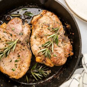 pork chops in a black cast iron skillet