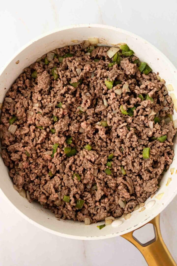 ground beef mixture cooked in a white skillet