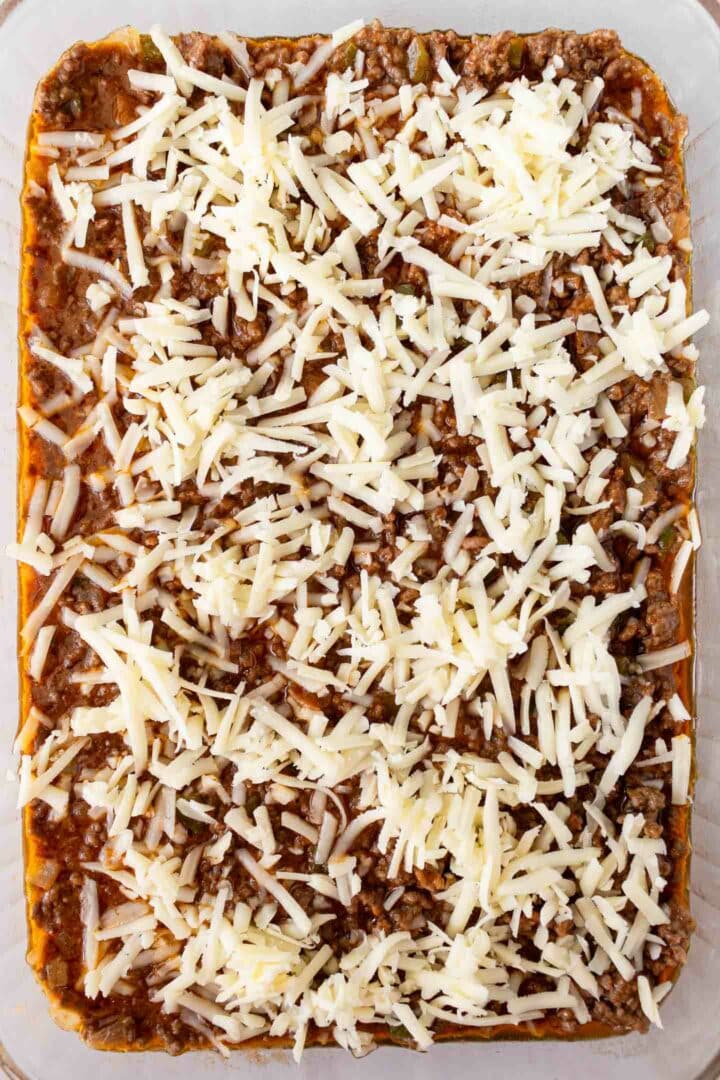 casserole in a dish with shredded cheese on top