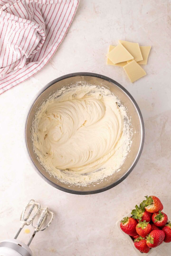 white chocolate mousse shown whipped in a mixing bowl