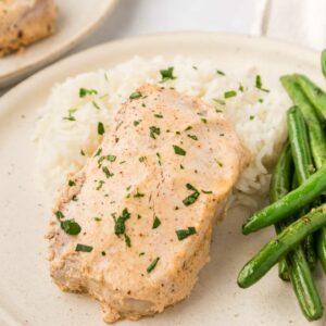 pork chops plated with mashed potatoes and green beans