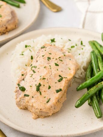 pork chops plated with mashed potatoes and green beans