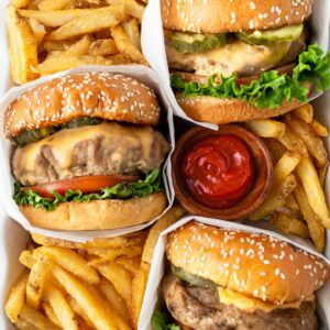 turkey burgers in a white dish with french fries