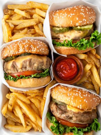 turkey burgers in a white dish with french fries