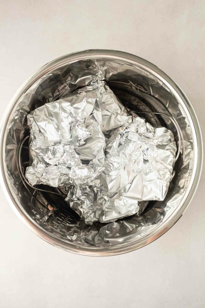 burgers wrapped in foil and placed in the pressure cooker