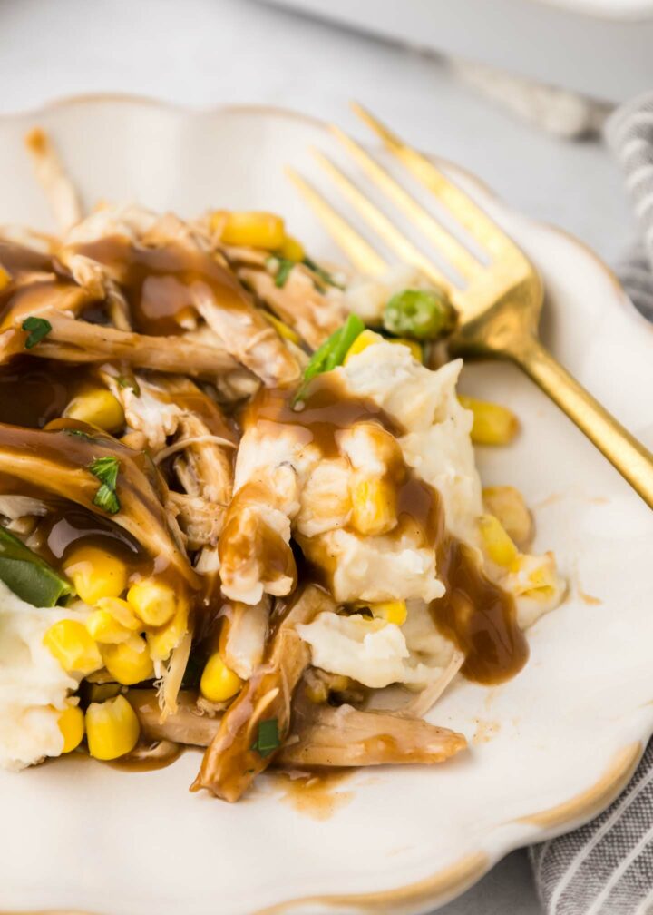 casserole on a white plate with a gold fork